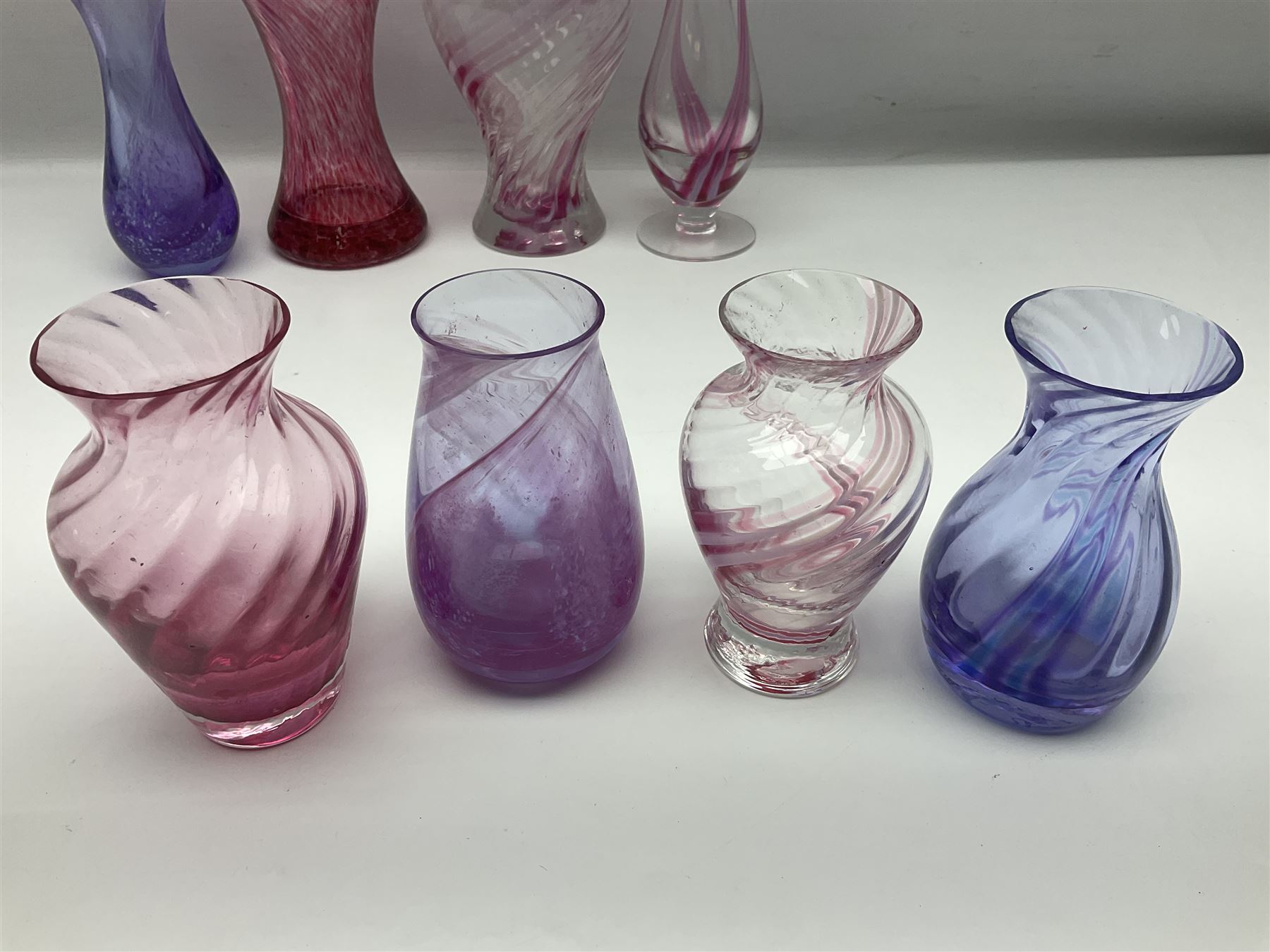 Collection of pink/purple Caithness glass vases, to include mottled and swirl designs, largest 20cm (19)