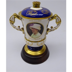  Aynsley limited edition commemorative two handled vase and cover 'To Celebrate The 80th Birthday of Her Majesty Queen Elizabeth II', painted panel of Buckingham Palace & printed portrait to reverse, produced by Peter Jones China no. 6/25 on wooden plinth, H24cm overall   