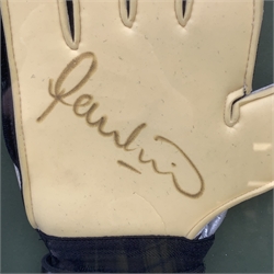 Pair of 1990s Leeds United goalkeeper's gloves signed by Nigel Martyn and Paul Robinson, mounted in a wall hanging framed display with signed pictures of each player 60 x 55cm. Provenance: the vendor was a coach at the keepers' club Leeds United and the gloves were signed for him.