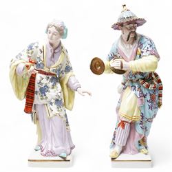 Pair of Continental polychrome Chinese male and female standing figures wearing floral robes H42cm