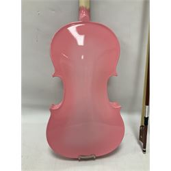 Zest full size pink violin, with a solid wood body and maple head, with matching pink bow and two further bows, in a hard case Length 60cm