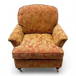 Duresta - Contemporary pair of upholstered armchairs, in red and gold damask style fabric, each with sprung seat and removable cushion back, rolled arms, on turned front supports with brass castors, square back legs 
