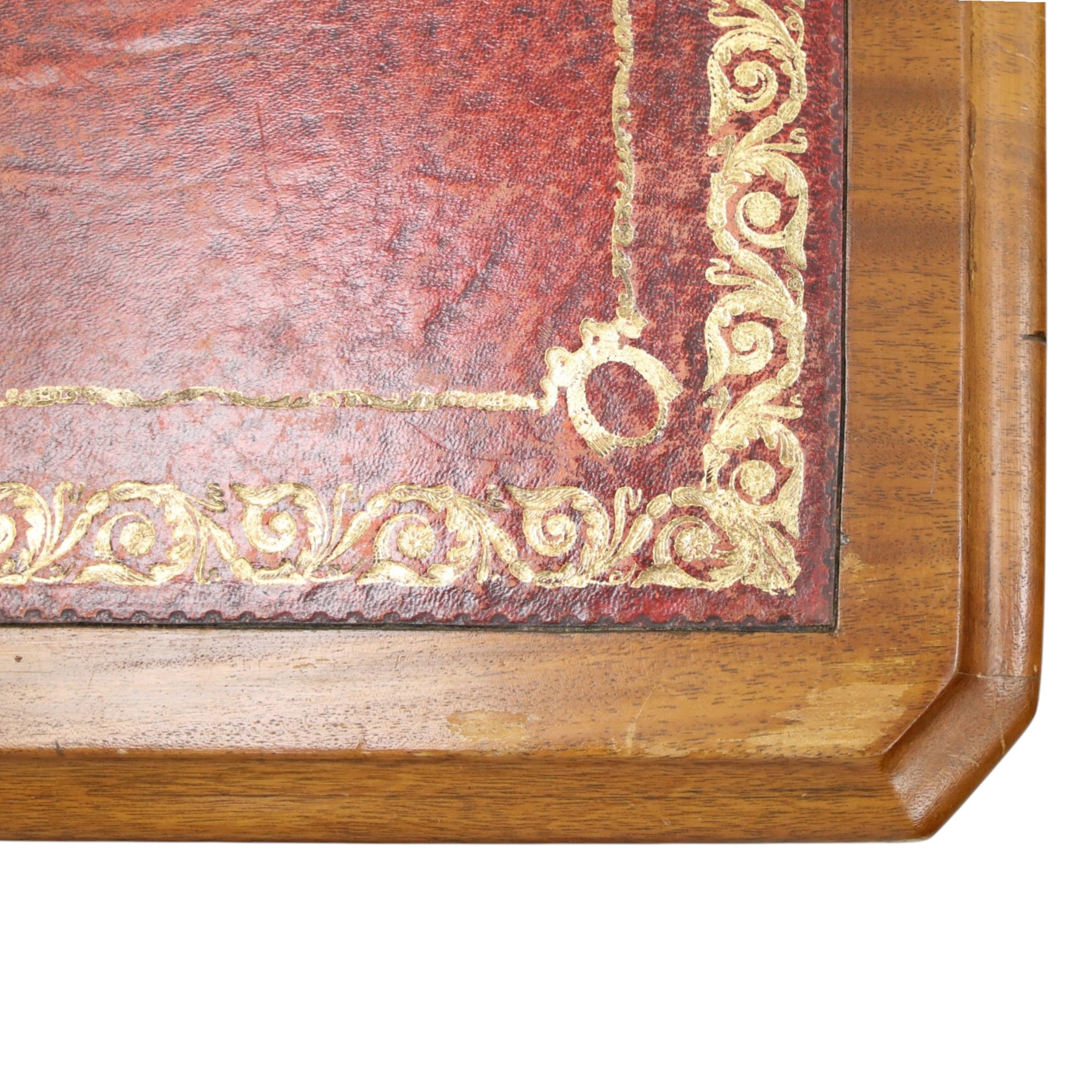 Late Victorian mahogany desk with red leather top, rectangular top with inset toold red leather writing surface, central long frieze drawer flanked by two short drawers, above pedestal with three graduating drawers with ring pull handles, on moulded plinth bases raised on castors