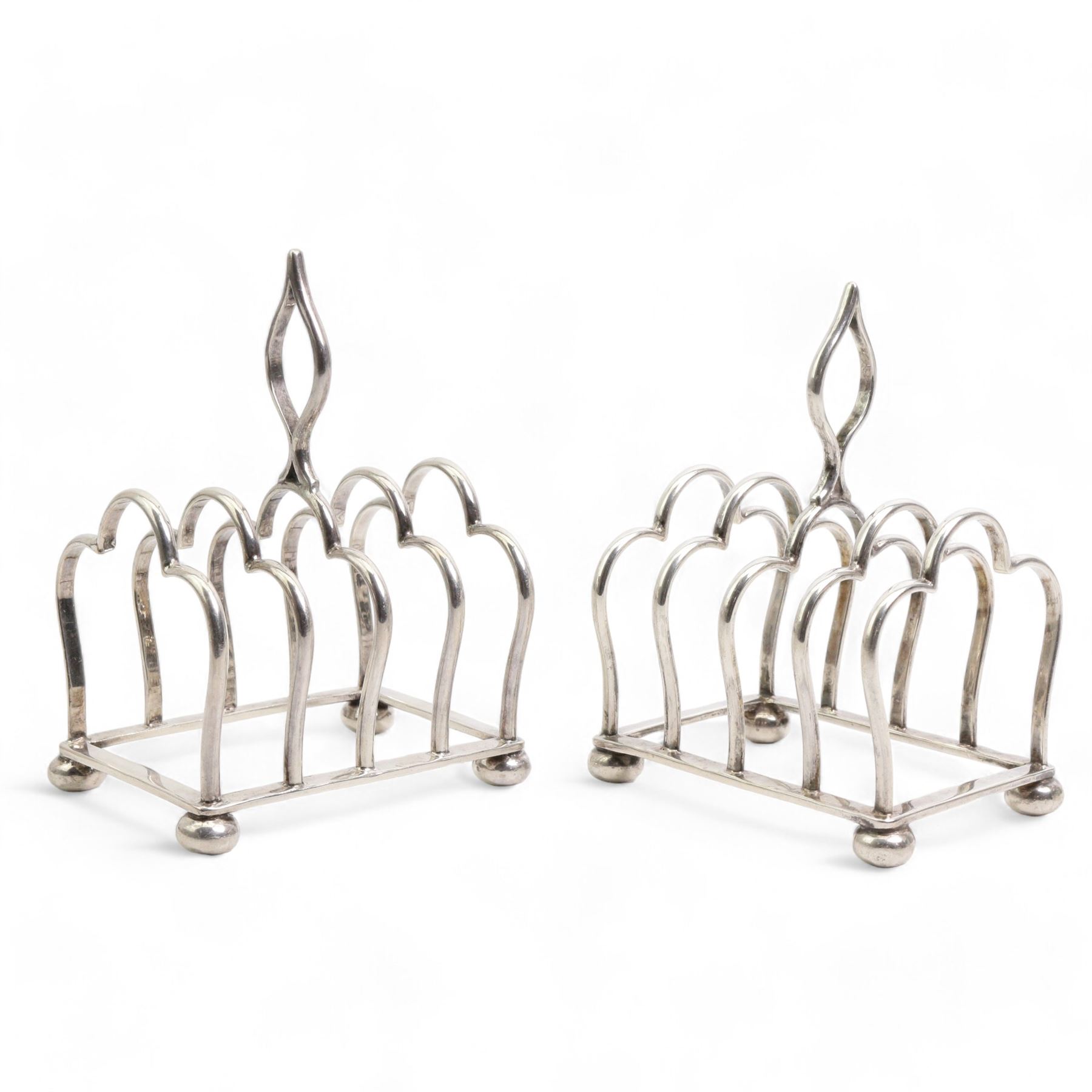 Pair of six division silver toast racks with Gothic loop handles on compressed bun feet, each L8cm Sheffield 1918/19 Maker James Dixon & Sons