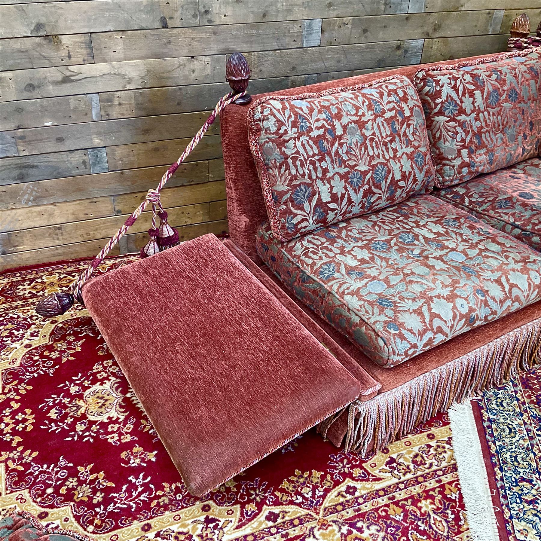 Knole type drop arm sofa with cushions in a traditional patterned upholstery,