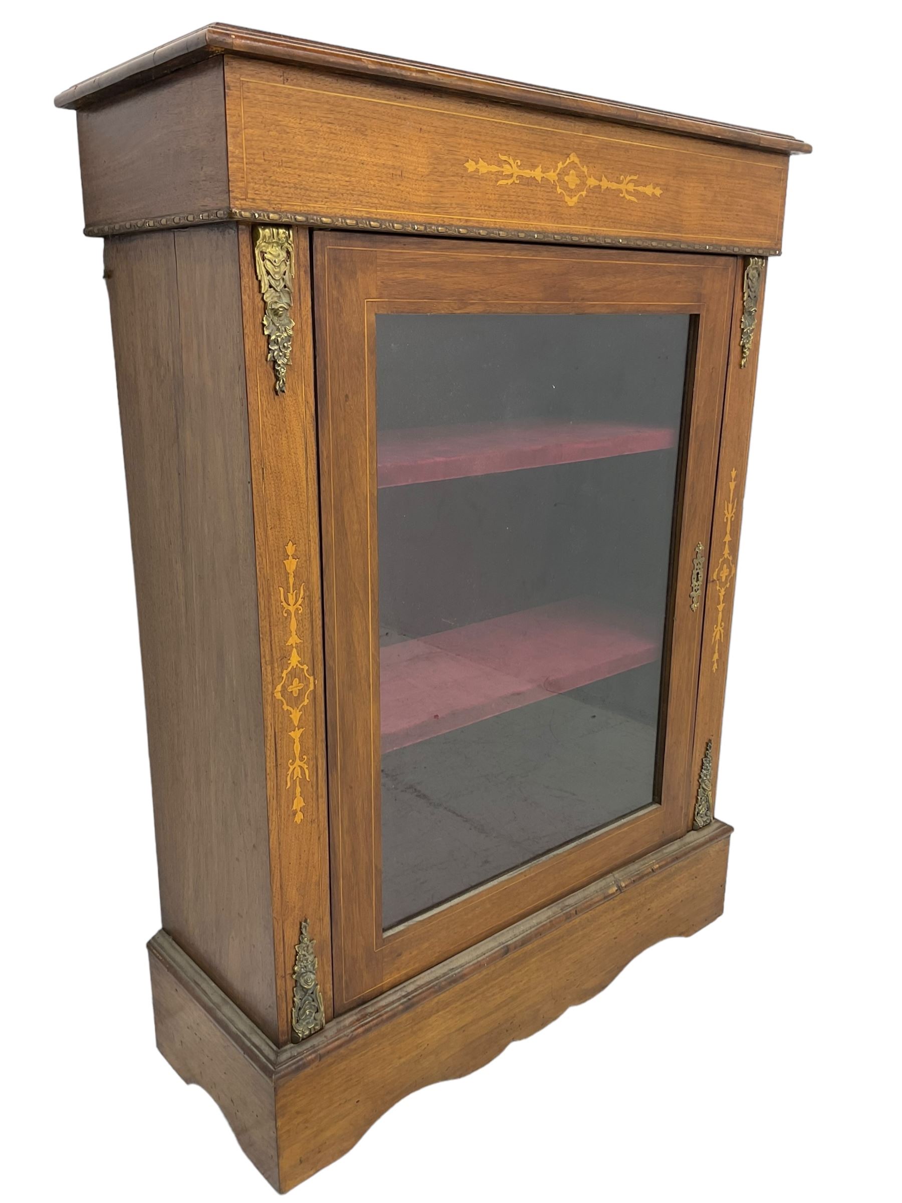 Victorian walnut pier cabinet, moulded rectangular top over inlaid frieze, enclosed by single glazed door, the uprights inlaid with extending stylised foliage decoration and cast gilt metal mounts, on moulded plinth base