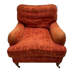 Howard style armchair, upholstered in red patterned fabric, on turned front feet