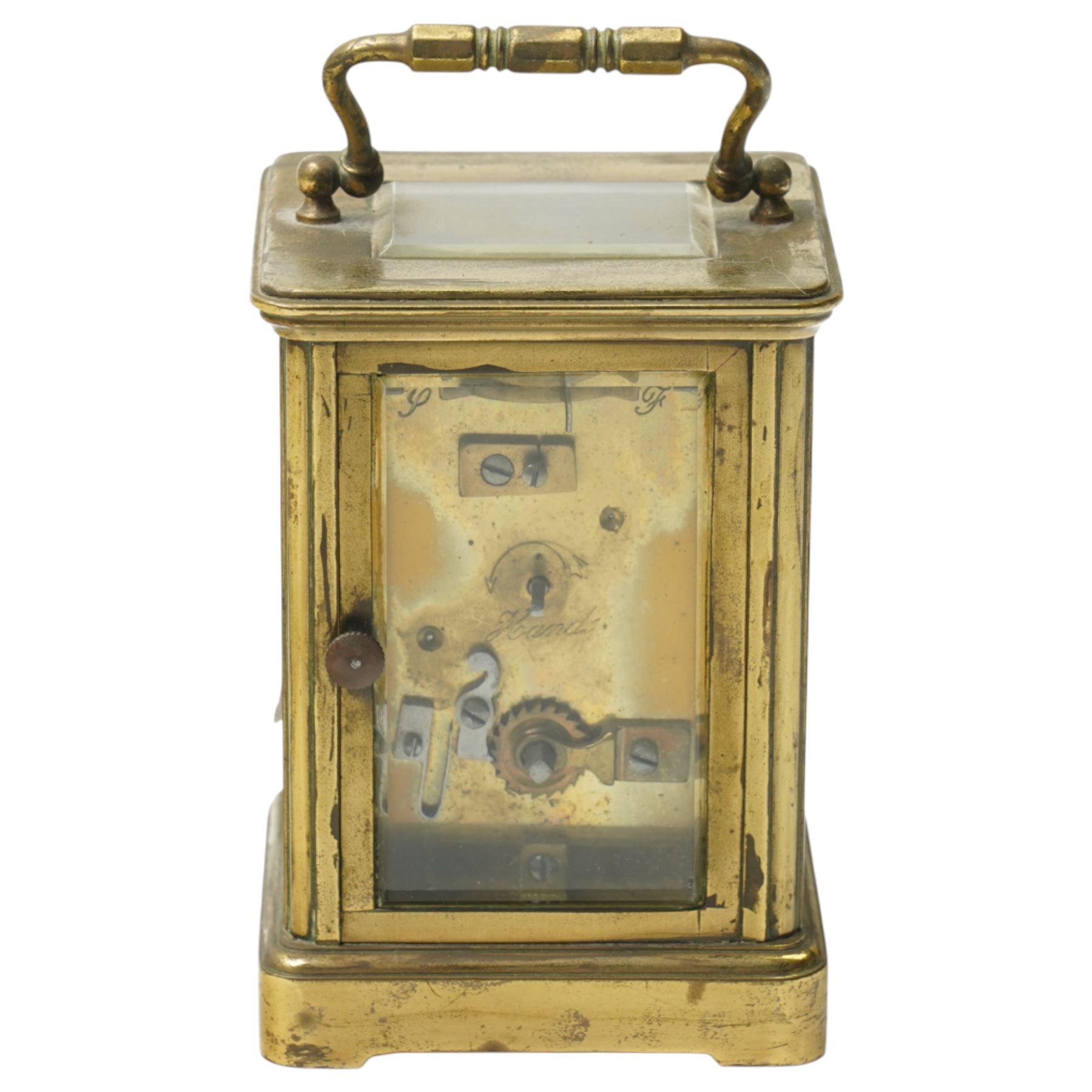 Two early 20th century 8-day French Carriage clocks- one with its original traveling case, lever platform escapement, enamel dial and Roman numerals, the other with a cylinder platform escapement, enamel dial with Roman numerals and five minute Arabic's.  