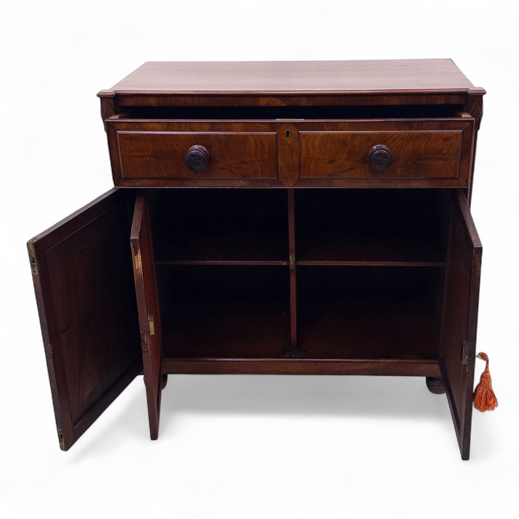 Regency mahogany secretaire cabinet, rectangular top over fitted secretaire drawer enclosing a tooled leather writing surface and pigeonholes, above a pair of panelled cupboard doors, raised on bracket feet