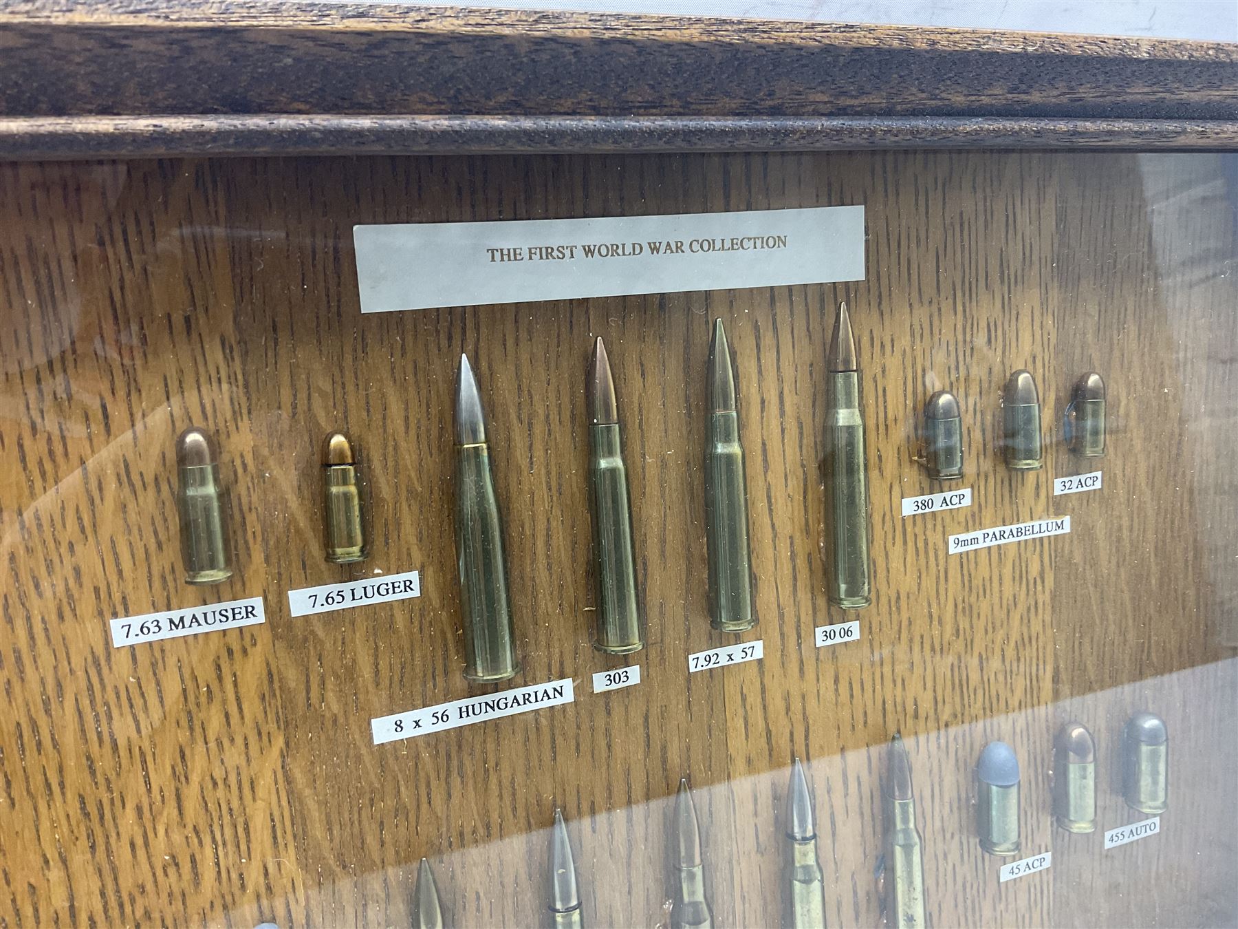 SECTION 1 FIRE-ARMS CERTIFICATE REQUIRED - Two cased specimen displays of annotated ammunition/cartridges - one entitled 'First World War Collection' containing twenty items including 7.63 Mauser, 7.65 Luger, .303, 7.62 x 54R Russian long, 455 Mk.II lead, 455 Auto etc; the other with sixteen items/clips including Musket cartridge, .577 Snider-Enfield, .577/45 Martini Henry, .303 Enfield Magazine, 7.62 Charger Clip, Specialised .303 rounds etc; largest case 41 x 76cm (2)