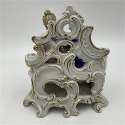 Figure group, probably Volkstedt, modelled as a courting couple seated before a table, the ornate bench and table conforming with and leading from the gilt heightened scrolling base, with blue painted mark beneath, H14.5cm
