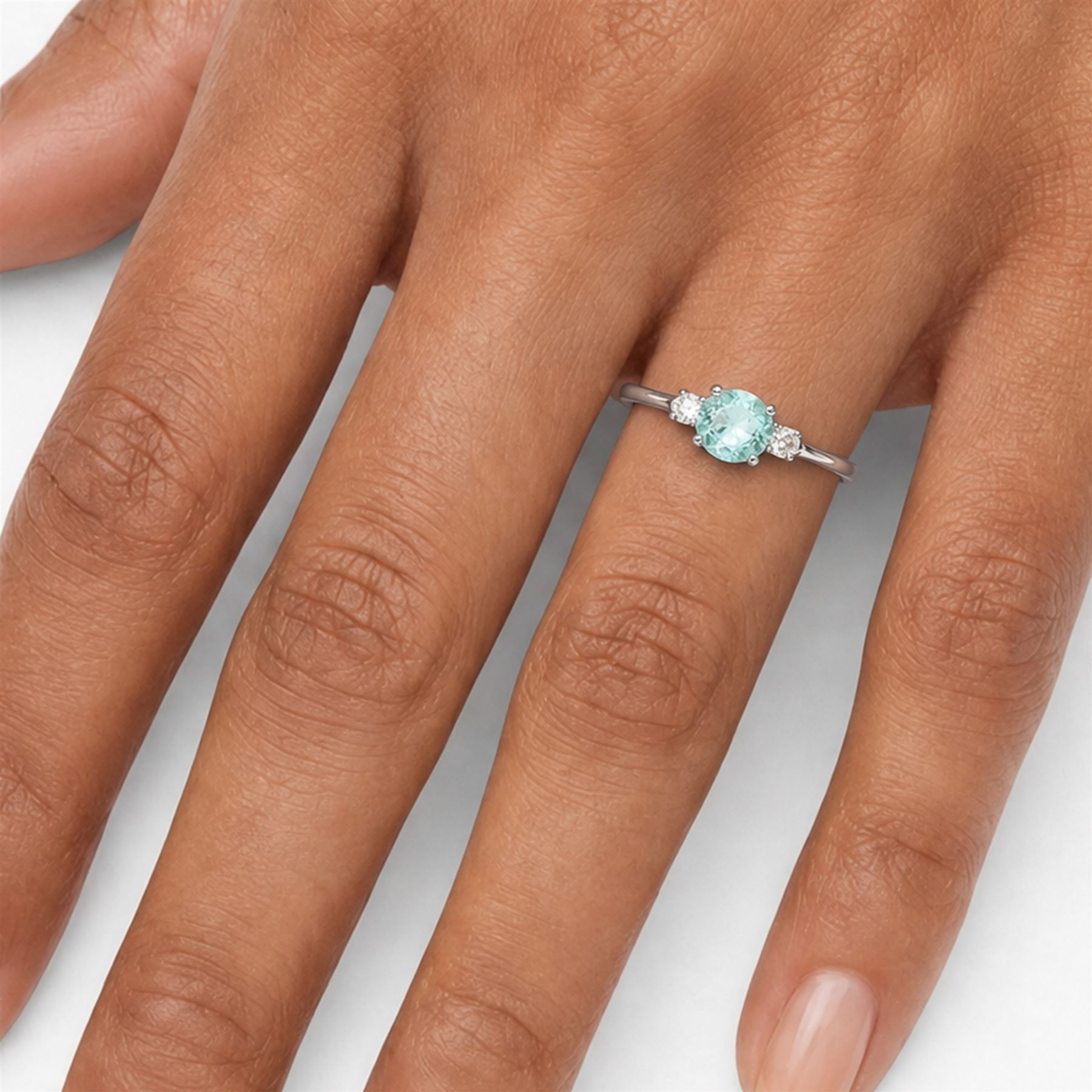 18ct white gold Paraiba tourmaline and diamond three stone ring, single round cut tourmaline of approx 1.50 carat, with a single round brilliant cut diamond set either side, hallmarked, total diamond weight approx 0.15 carat