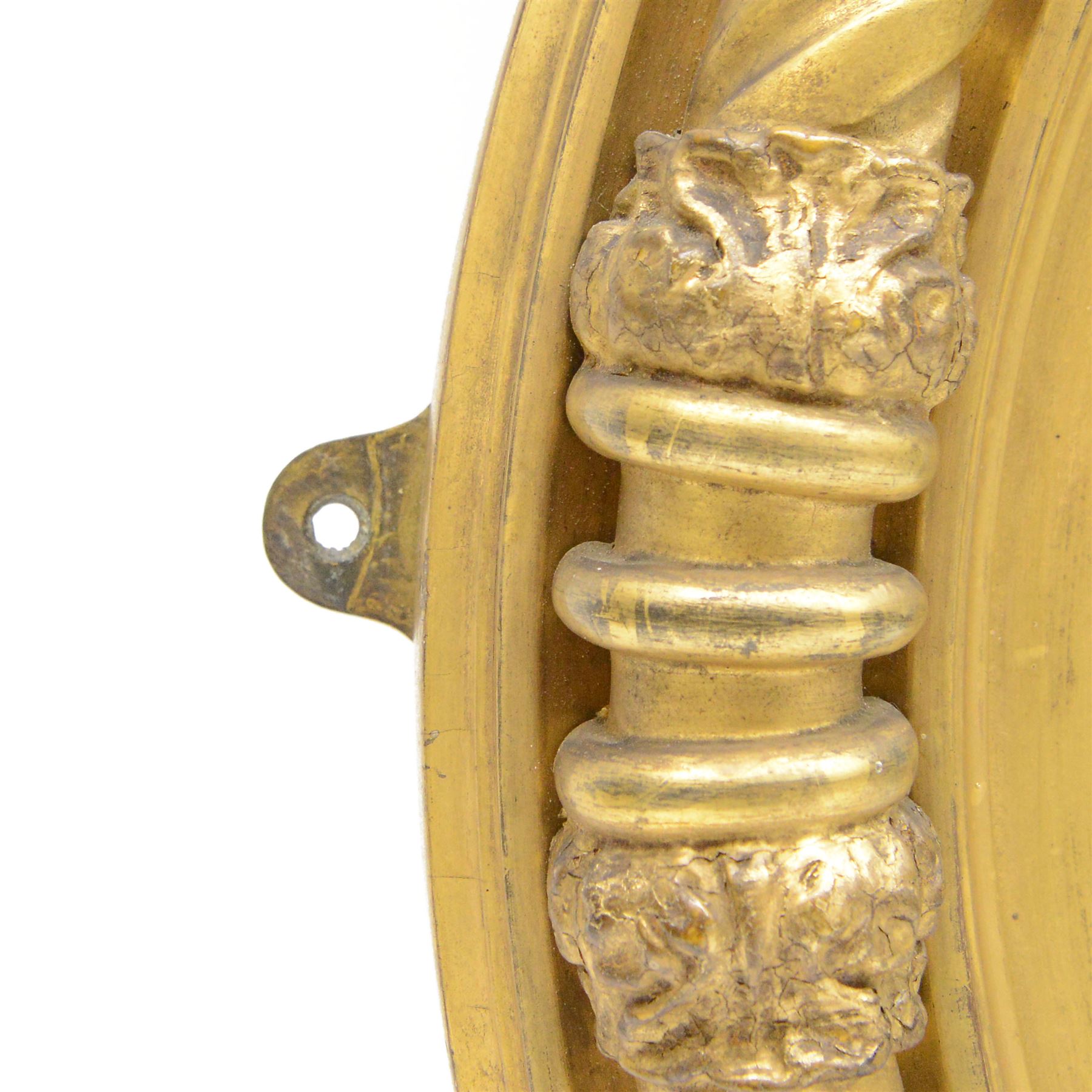 Regency gilt wood and gesso wall mirror, stag pediment with trailing oak leaves and acorns, extending curled acanthus leaves and fruiting vines, the convex mirror plate enclosed by rope twist and acanthus leaf decorated wreath