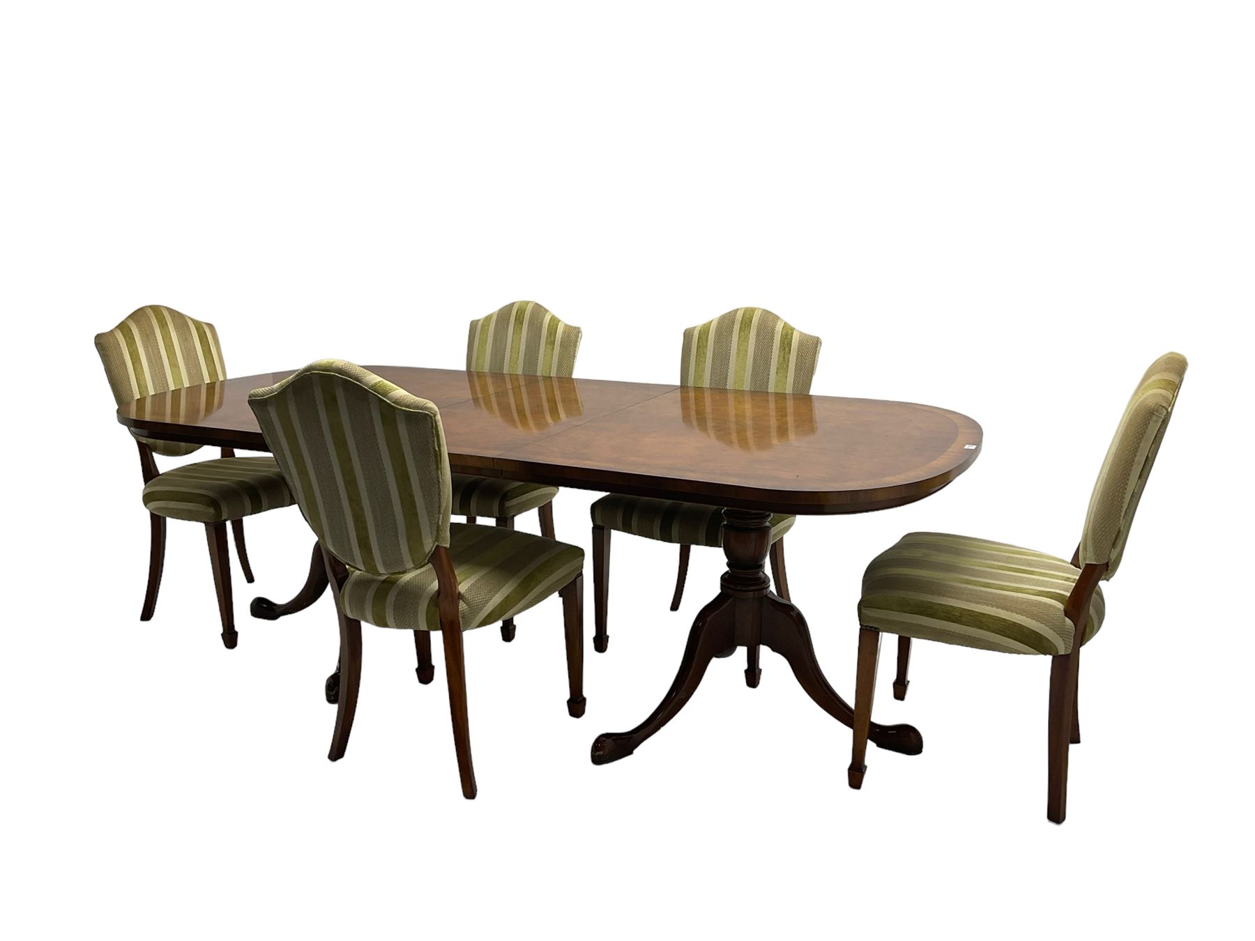 Regency design walnut twin pedestal extending dining table, rectangular burr top with rounded corners and crossbanding, raised on turned vasiform columns with tripod base, with additional leaf (D107cm W184cm/230cm, H76cm); and set eight (6+2) shield back dining chairs, upholstered in striped laurel green fabric, raised on tapering supports with spade feet, retailed by Geoffrey Benson