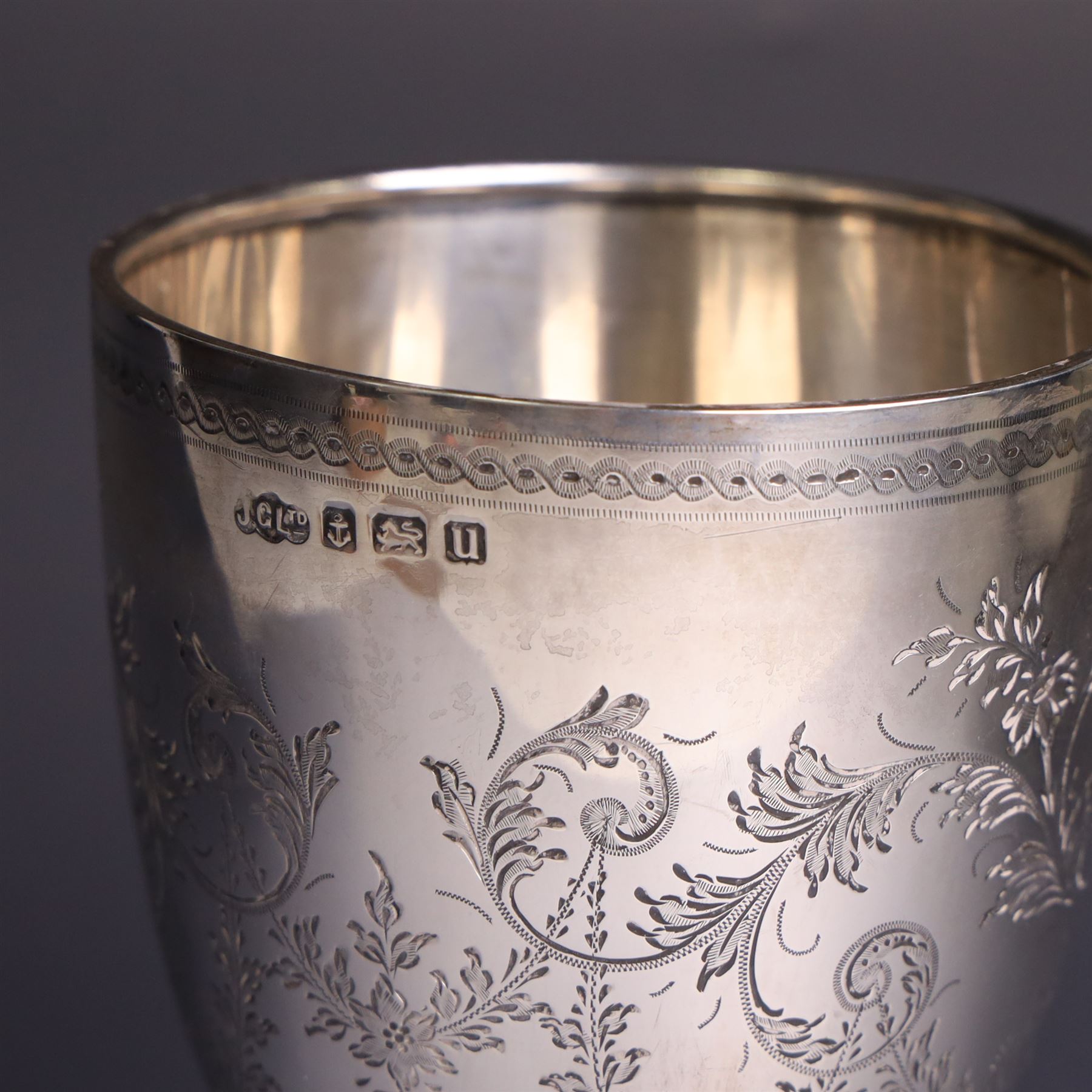Early 20th century silver trophy cup, with engraved foliate and scrolling decoration upon a domed circular foot, hallmarked Joseph Gloster Ltd, Birmingham 1919, H18cm
