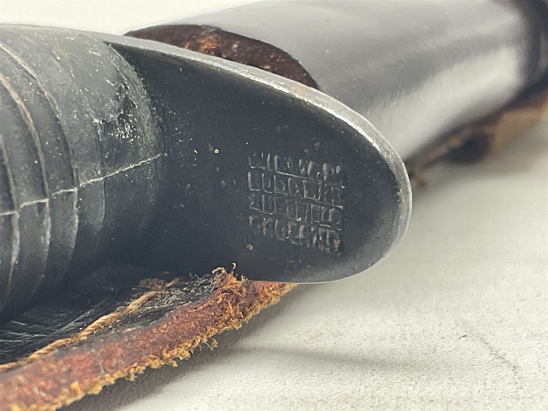 Third Pattern Commando Knife or Dagger with 17.5cm flattened diamond section blade and regulation black painted ribbed copper hilt with brass pommel nut; stamped William Rodgers Sheffield England to the cross-piece; in black painted brass mounted leather scabbard L34.5cm overall