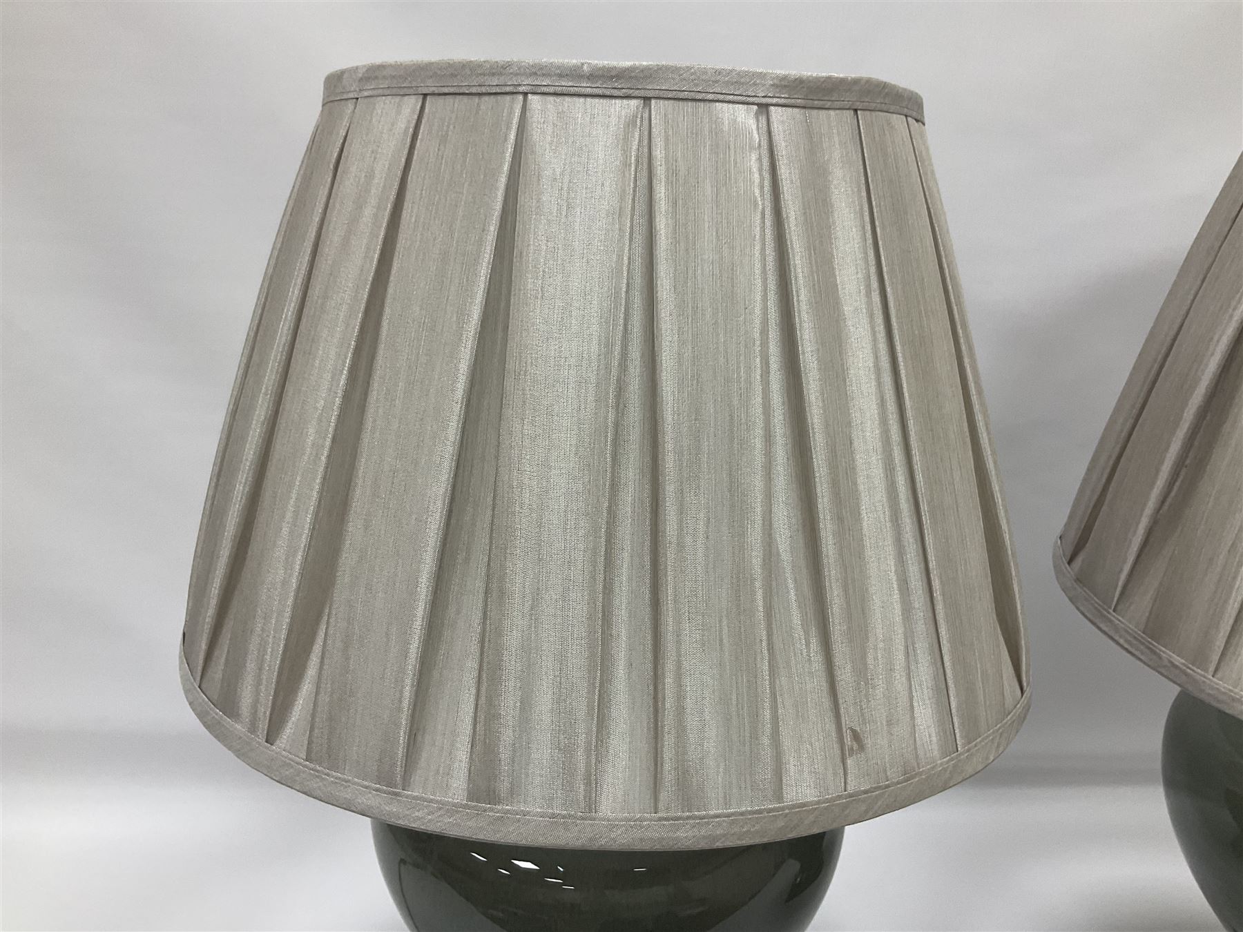 Pair of table lamps of squat baluster form, with a crackle glaze to a dark grey ground, upon a square base, including shade H57cm