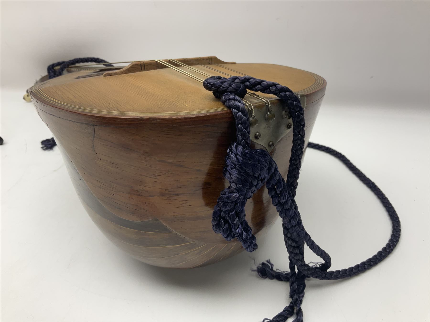 Late 19th/early 20th century Italian lute back mandolin with segmented back and spruce top; bears maker's label for Pietro Tonelli Napoli; together with a mandolin instruction booklet and a folding music stand L60.5cm
