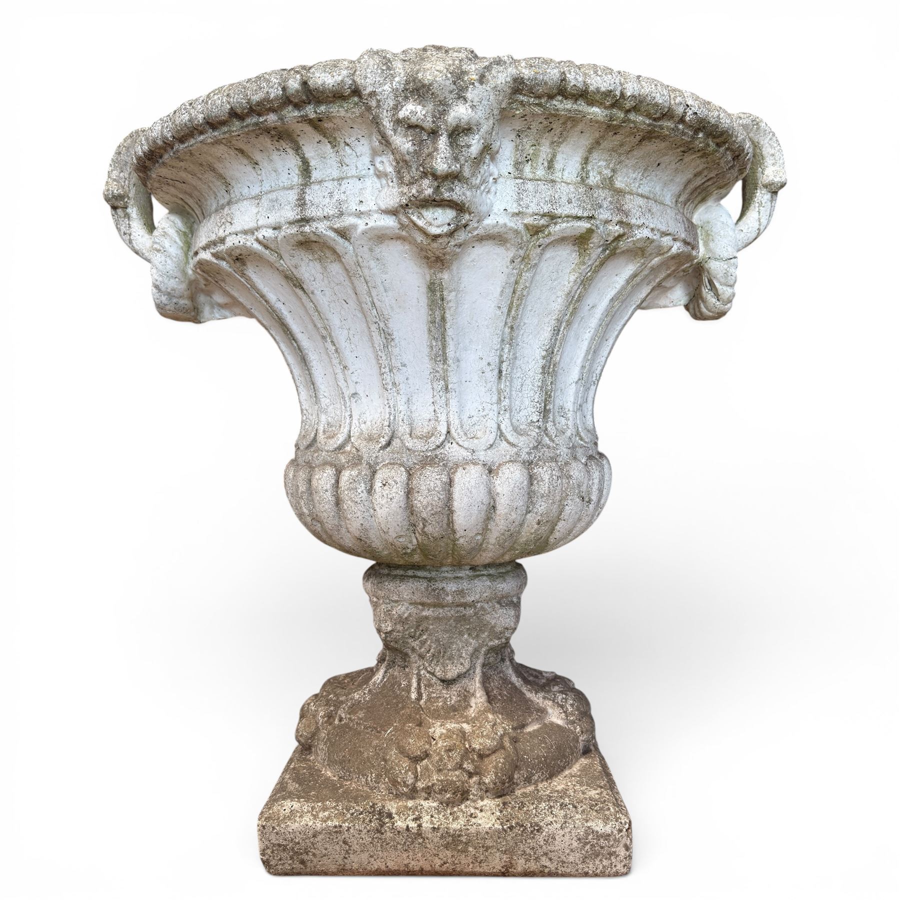 Pair of Neoclassical design cast stone garden urns, each of campana form with fluted body and gadrooned underbelly, decorated with faun/satyr opposing masks and ropetwist handles, with floral and mask design to the socles, raised on square bases, finished in weathered white patina