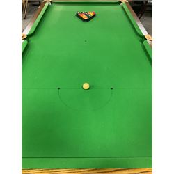 Late 20th century oak slate bed billiard table, on six turned column supports,  together with cues, ball set, baize brush, triangles and scoreboard 