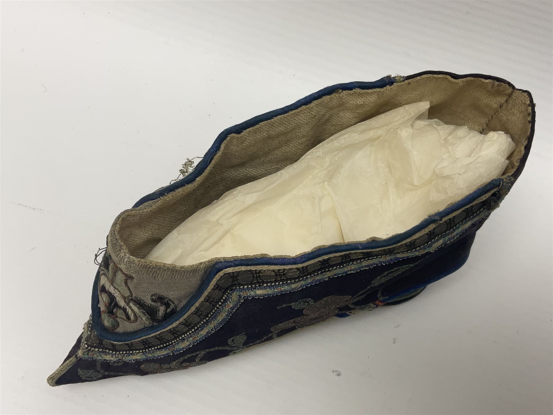 Pair of Chinese silk embroidered lotus shoes, for bound feet, a blue ground with floral detailing L15cm