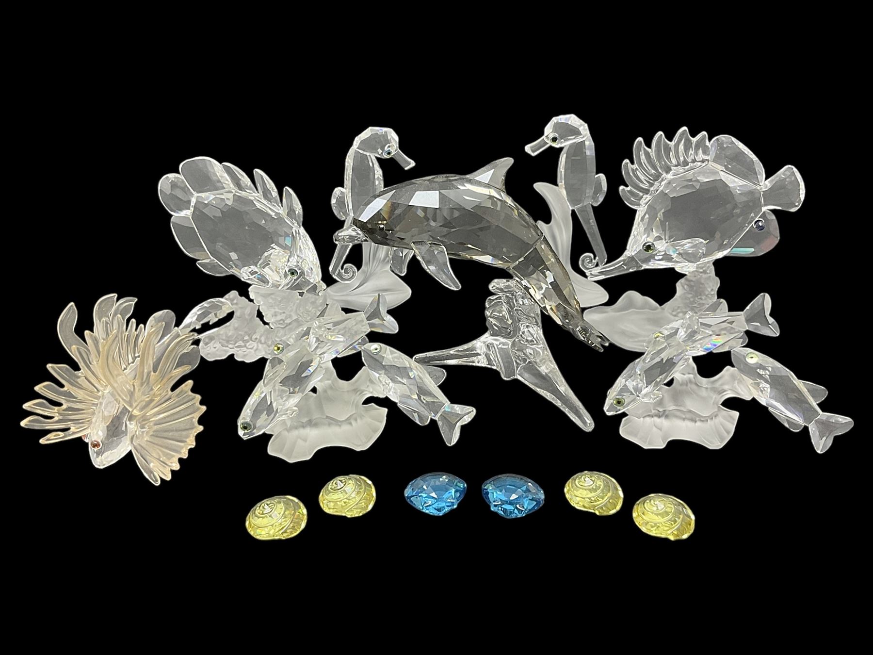 Swarovski Crystal sea creatures, comprising lion fish and dolphin, both with coloured elements, together with two seahorses, two small fish groups, butterfly fish, longnose butterfly fish and six coloured shells, tallest H8.5cm
