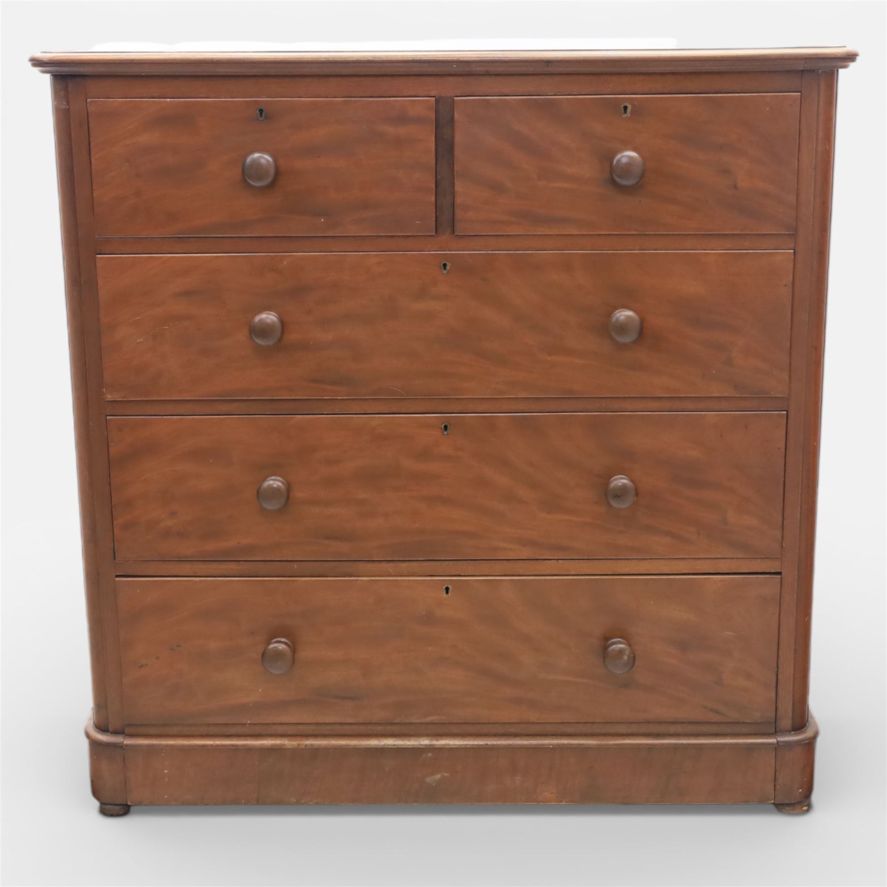 Mid Victorian flame mahogany chest of drawers, the moulded bow front top over two short and three long graduated drawers, fitted with turned wooden knob handles, flanked by rounded front corners continuing to plain sides, raised on a plinth base