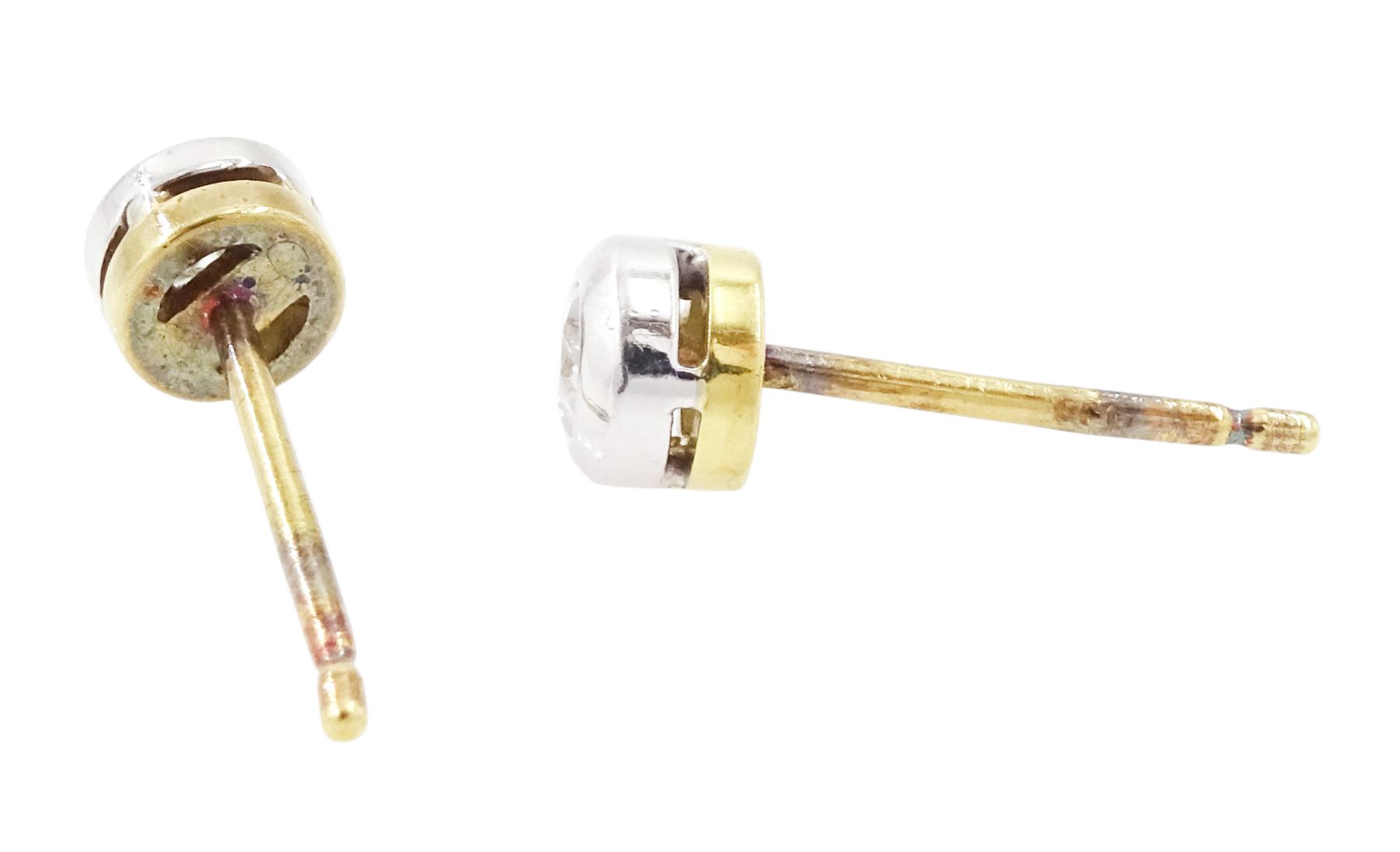 Pair of 18ct white and yellow gold diamond earrings, each stud bezel set with a round brilliant cut diamond, London 1998, total diamond weight 0.25 carat