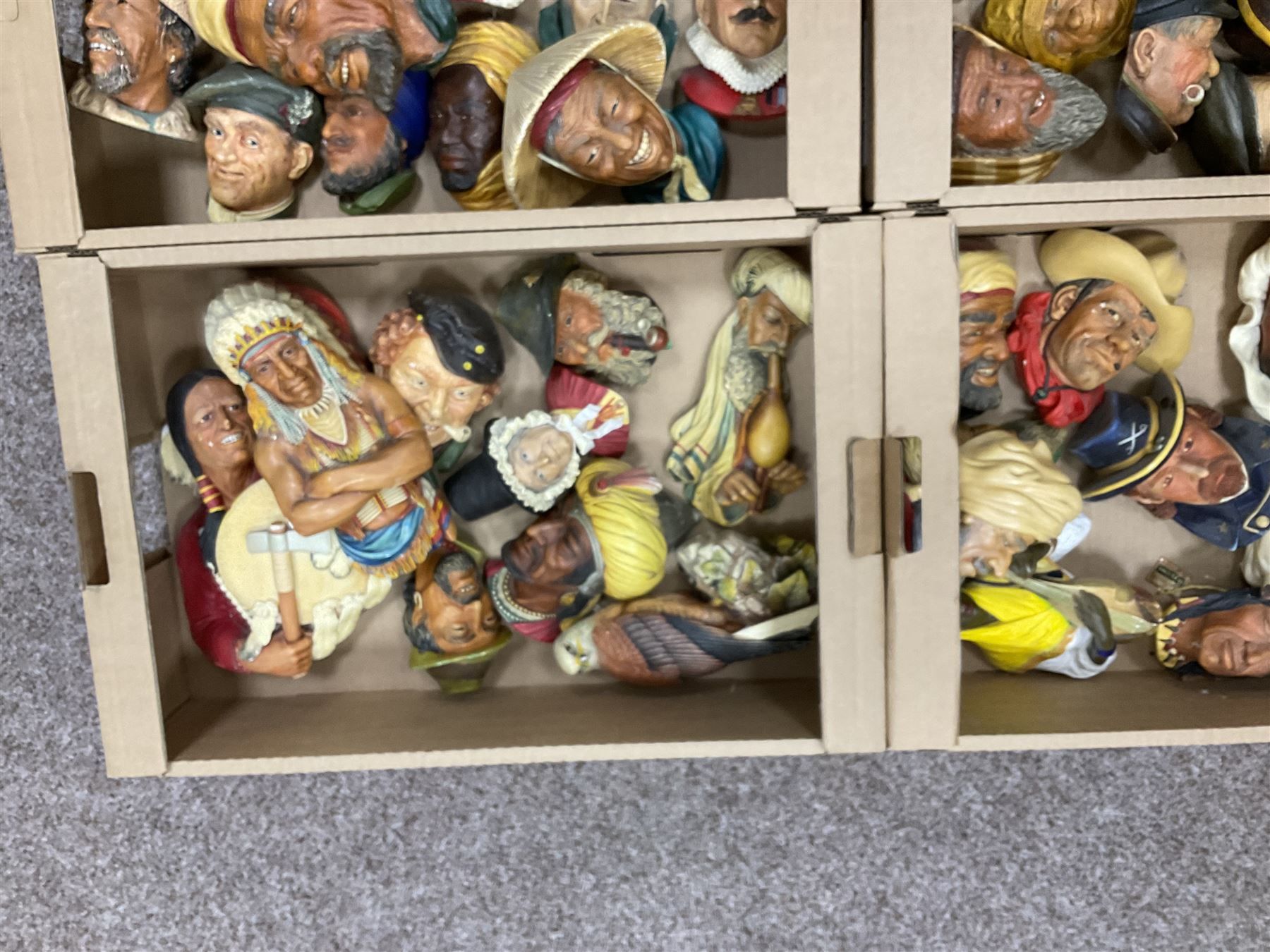 Large collection of Bossons plaster wall-masks, including including fisher man, cowboys, native Americans, etc, in four boxes 