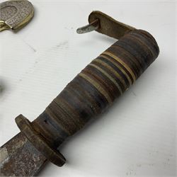 Moroccan jambiya dagger with 24.5cm plain curved blade stamped LONDON to the ricasso area, the hilt and scabbard overlaid with plain sheet brass to the back and ornate silver coloured metal to the front; waisted grip and arched pommel; two pyramid mounts to the scabbard L41cm overall; large billhook with curving blade and stacked leather washer grip; and a reproduction halberd blade (3)