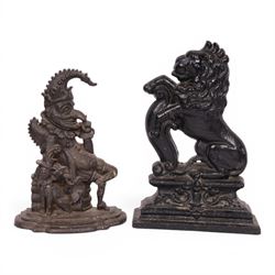 Victorian cast iron doorstop in the form of a rampant lion on a plinth base, together with...