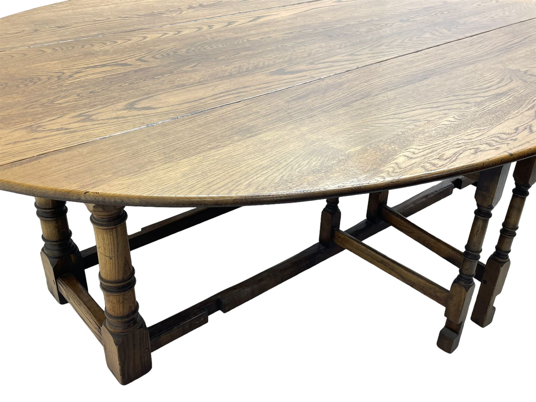 Large 18th century design oak wake or dining table, oval drop-leaf top, turned supports with double gate-leg action base, united by moulded stretchers 