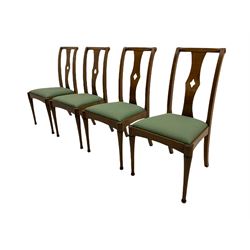 Set of eight contemporary walnut dining chairs, curved backs set with shaped splats with pierced detail, drop in upholstered seat cushions, on turned supports 