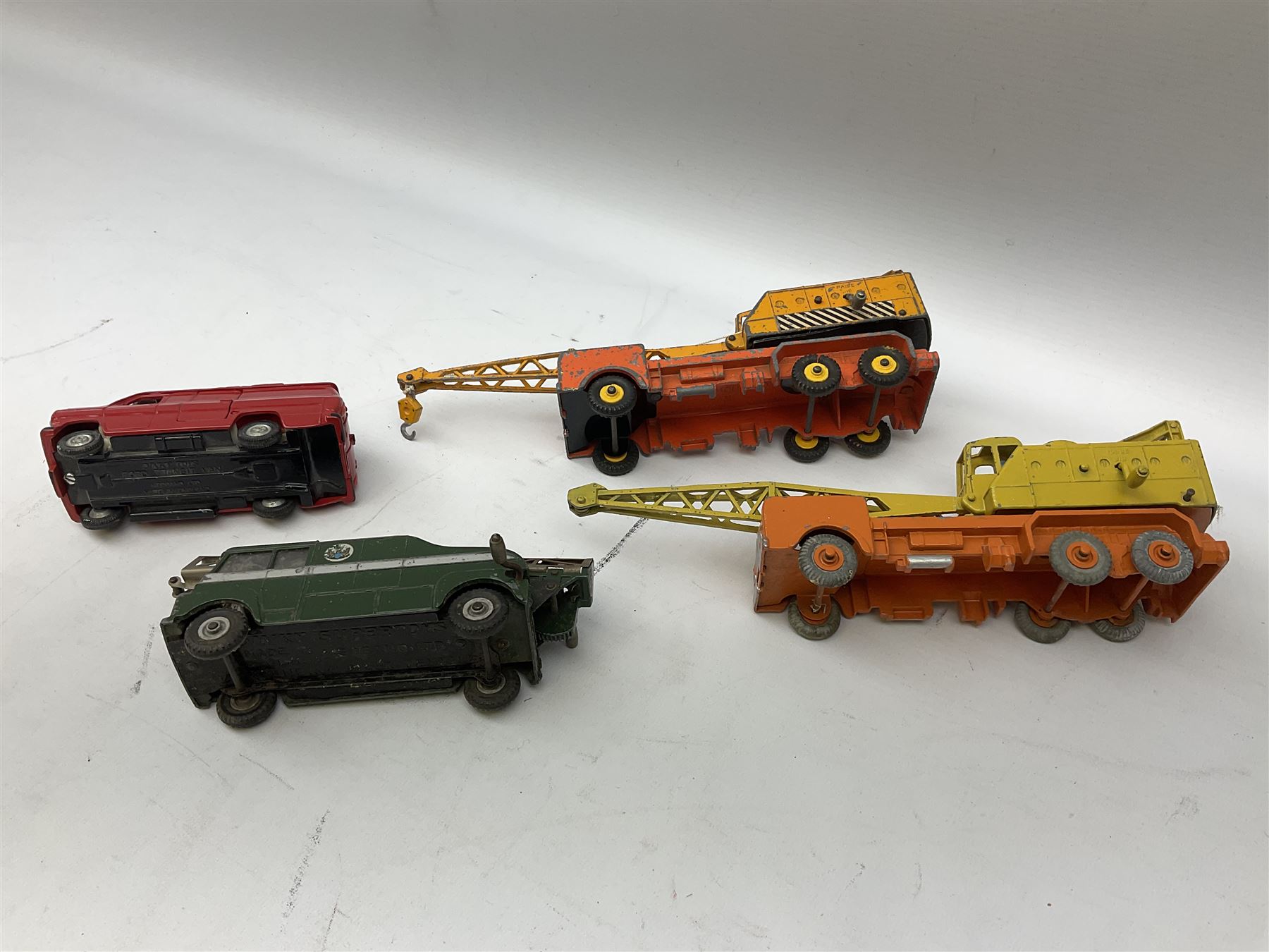 Dinky - thirteen unboxed and playworn die-cast commercial vehicles including two Supertoys 20-Ton Lorry-Mounted Cranes; Leyland Octopus Tanker; Fire Engine No.955; Extending Mast Vehicle No.969; two TV Roving Eye Vans No.968; three Ford Transit Vans; Brinks Armoured Car No.275; etc