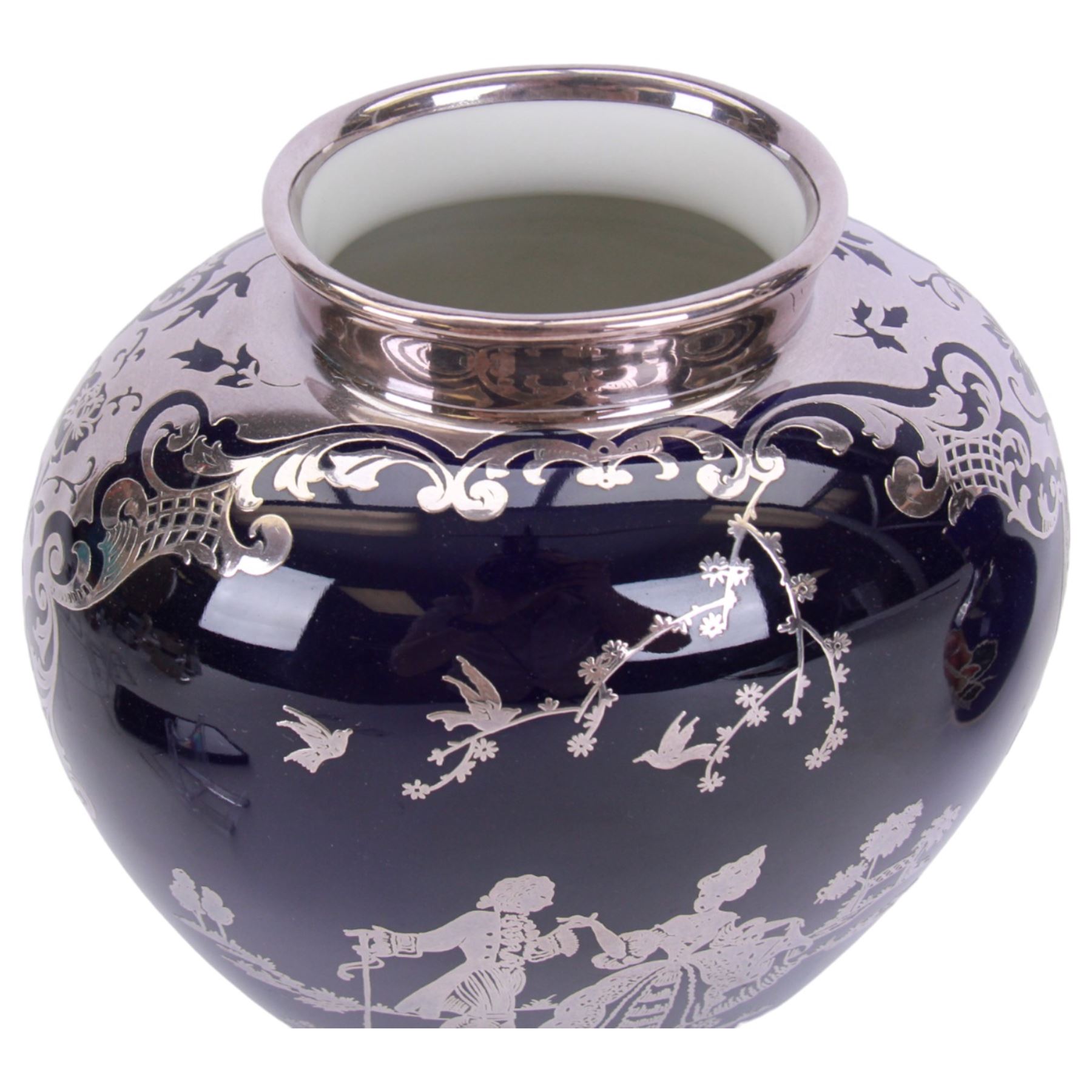 Heinrich vase with silver overlay depicting figures in period dress upon a cobalt blue ground, together with German vase with floral decoration and silver overlay, largest H21cm 