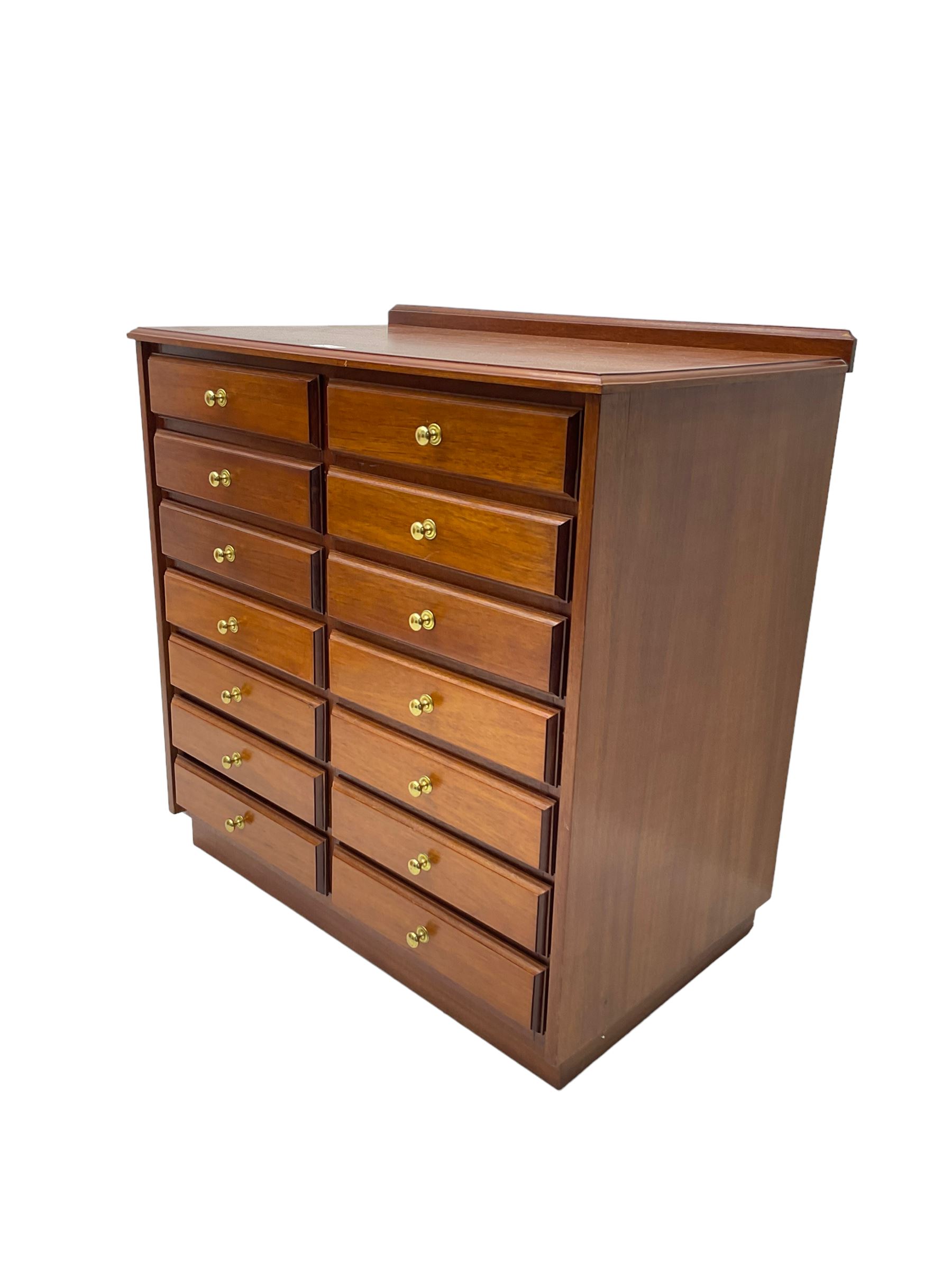 Late 20th century teak sheet music cabinet, fitted with fourteen drawers on plinth base 