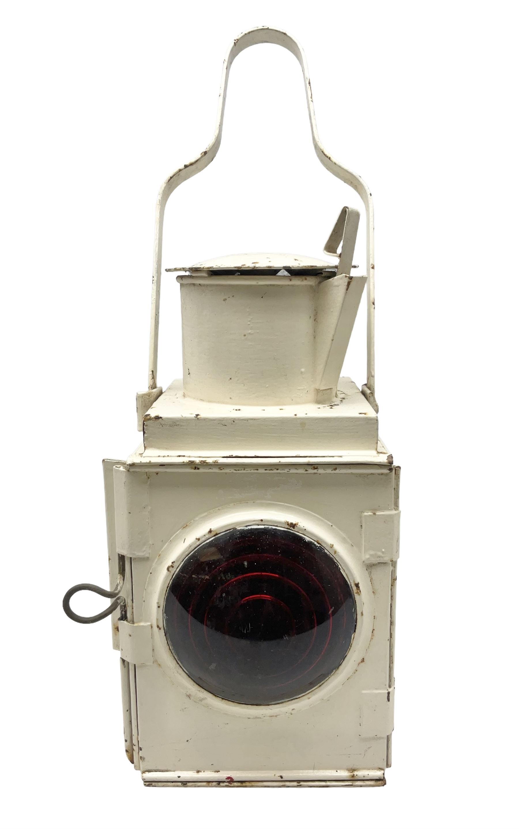 White painted railway lamp, the hinged door with red bullseye glass lens, with tall swing carrying handle, H52cm incl handle