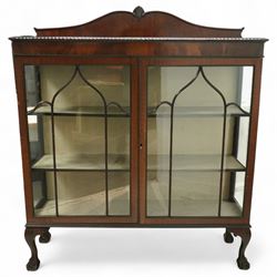 Early 20th century mahogany display cabinet, shaped pediment over a dentil moulded cornice, twin astragal glazed doors enclosing three shelves, raised on cabriole supports with pad feet
