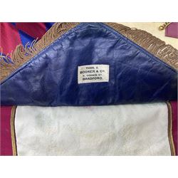 Two Masonic kid leather aprons, one with sash and cuffs, the other with sash, each marked 'Yorkshire North and East Ridings'; and three other unmarked Masonic aprons with sashes