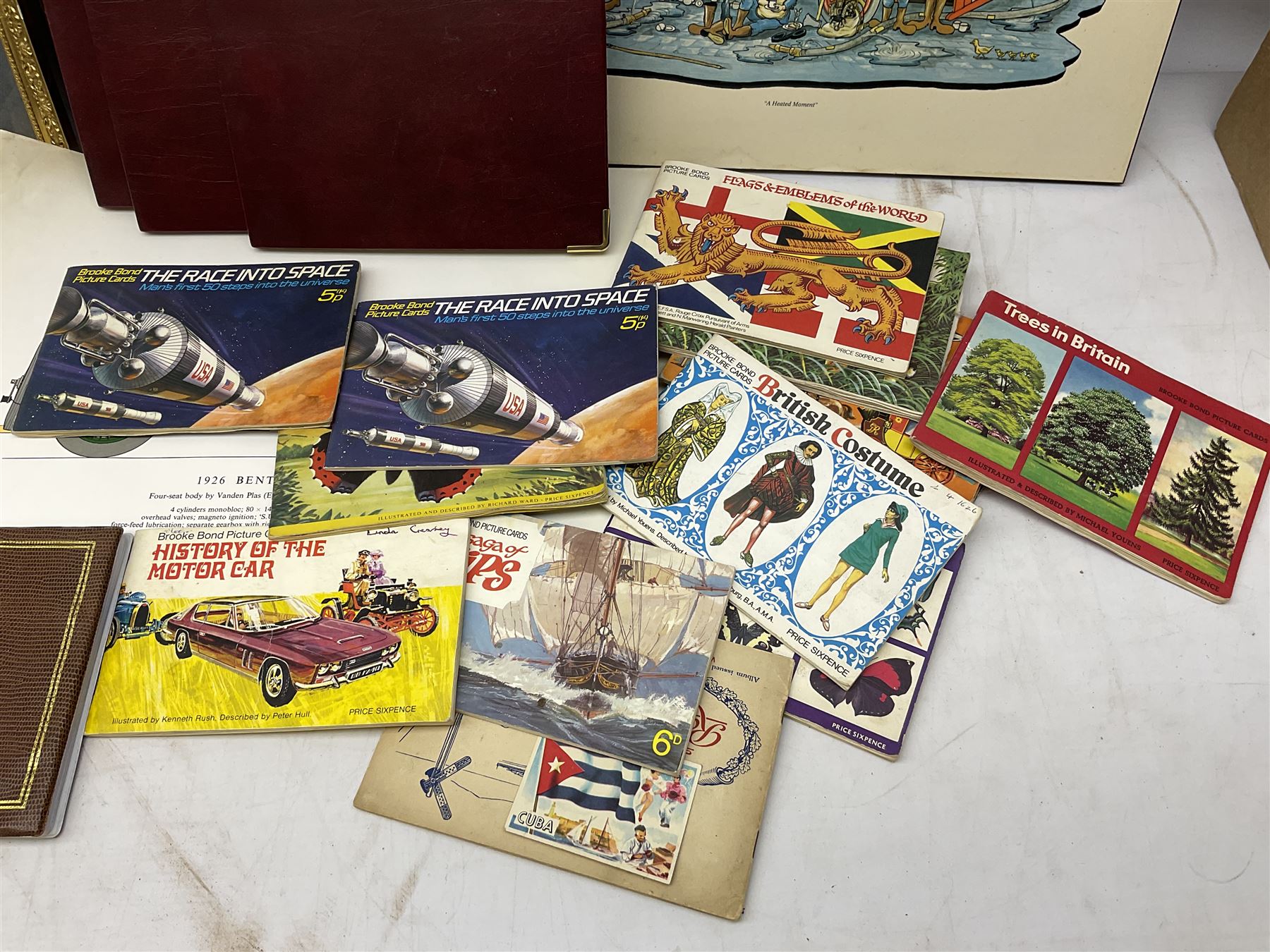 Set of four framed coloured prints humorous fire brigade related, after Chris Reynolds, together with Brooke bond picture cards, to include Asian wild life, the race into space, travel through the ages etc