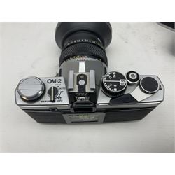 Four Olympus camera bodies, including Olympus OM10, serial no 20744269, with 'Olympus OM-System Zuiko Auto-S 50mm 1:1.8' lens serial no 3633644, Olympus OM-2 camera body serial no 460280 with 'Olympus OM-System G.Zuiko Auto-s 1:1.4 f=50mm' lens, serial no 729750, etc 