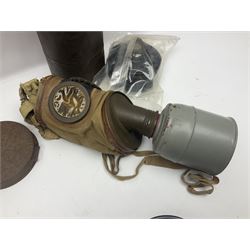 Four WW2 French gas masks in tins with some accessories