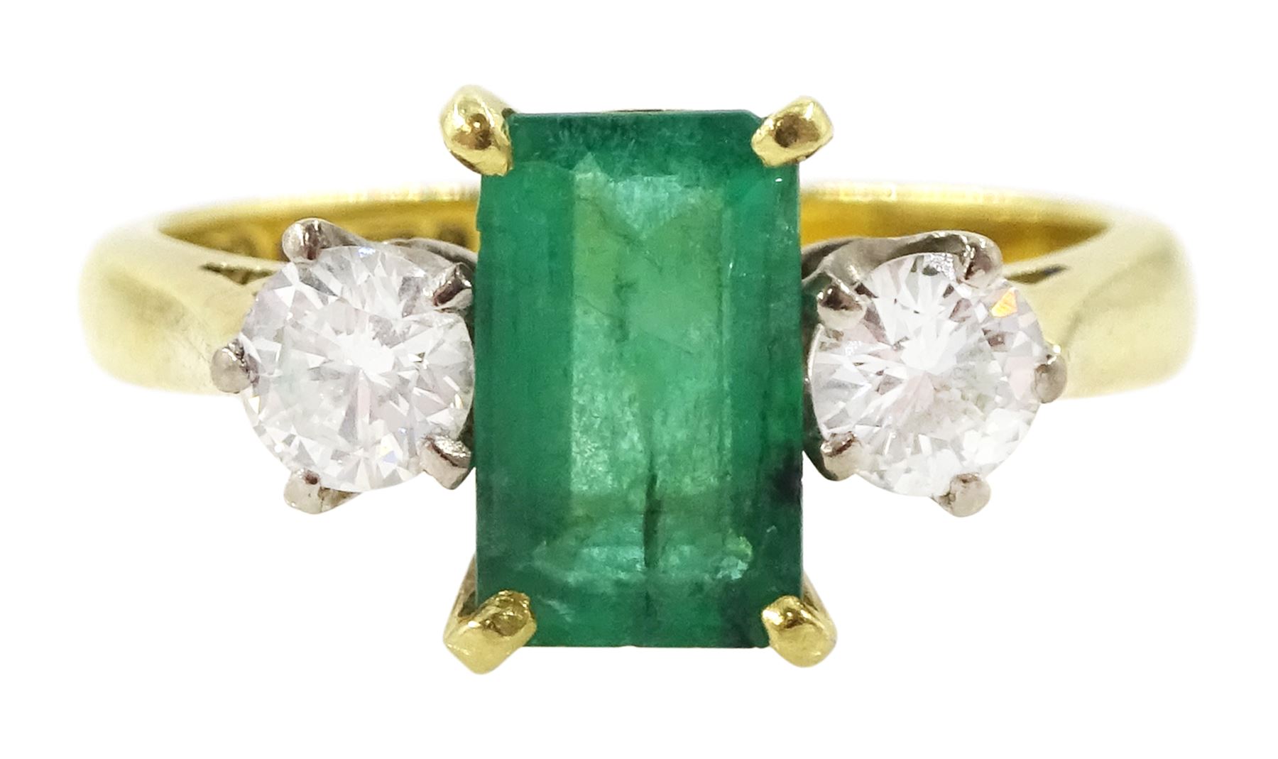 18ct gold three stone octagonal cut emerald and round brilliant cut diamond ring, Sheffield 1981, emerald approx 0.80 carat, total diamond weight approx 0.35 carat