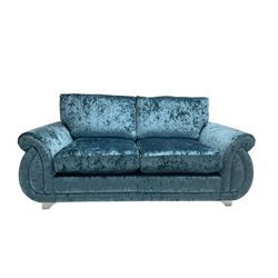 DFS - two seat sofa of scrolling design, upholstered in blue crushed velvet, with matching armchair