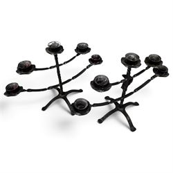 Collection of wrought iron candle stands, comprising five-light and three-light floor-standing candelabra with scrolling branches, and a pair of five-light table candelabra of naturalistic branching form