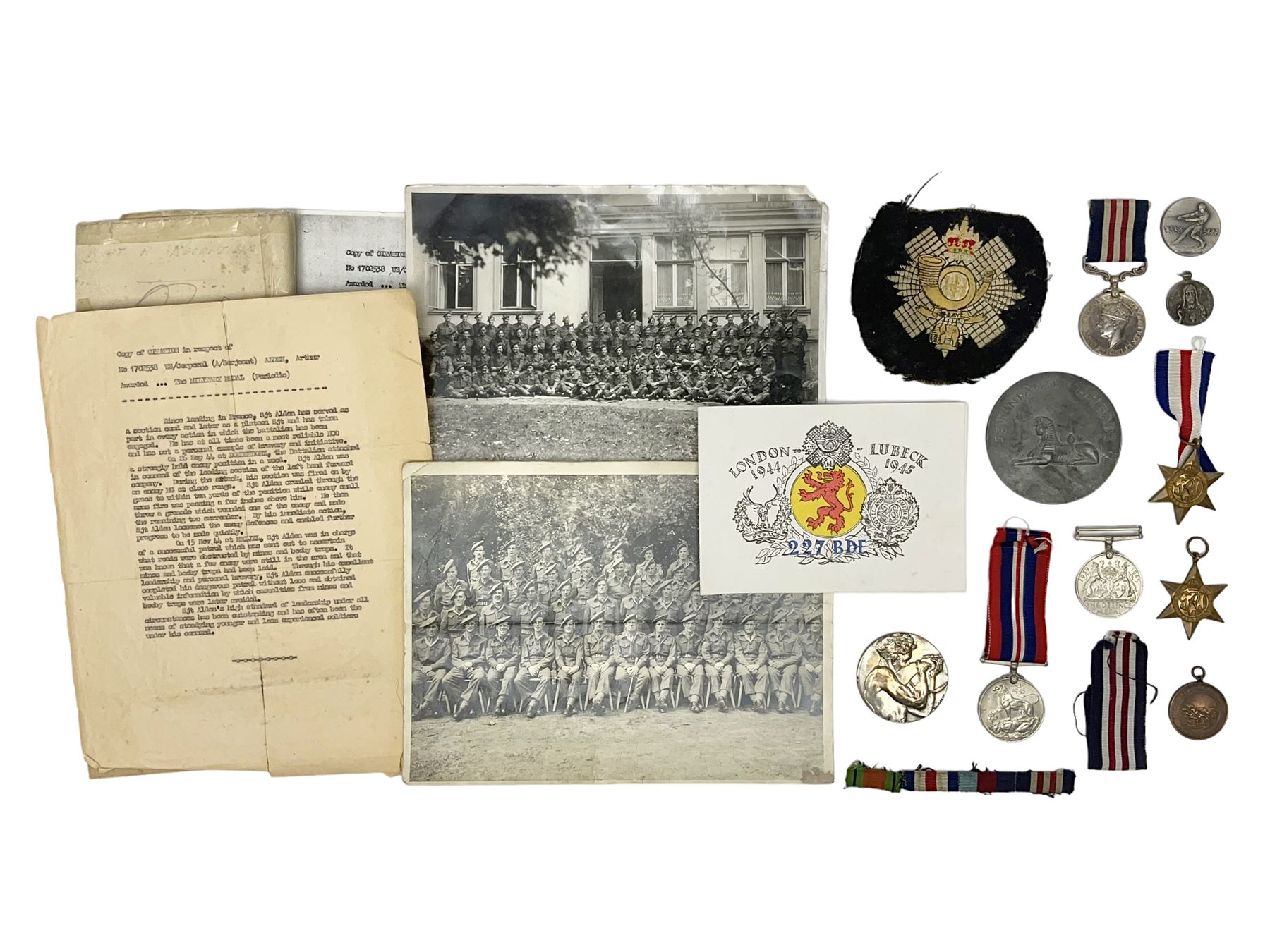 WW2 Highland Light Infantry Military Medal group of five comprising MM, 1939-1945 War Medal, Defence Medal, 1939-1945 Star and France and Germany Star; three with ribbons; awarded to 1702538 A. Sjt. A.L. Alden H.L.I.; various copies of his citation giving details of his bravery on 26 Sep 44 at Donderdonk France when he single-handedly silenced an enemy machine gun nest. The citation also mentions a further heroic act on 15 Nov 44 when he risked his life to obtain vital information on the position of enemy mines and booby traps saving the lives of many other soldiers; the collection also comes with two contemporary group photographs of his Highland Light Infantry regiment, copy photograph of him being awarded the MM by Field-Marshall Montgomery, two post-war tug-o-war medallions and other items; together with a shooting medallion awarded to Gnr. J. Alden (his brother John) inscribed 123 L.A.A. Regt. R.A. Rifle Meeting Harburg 1945 and a Life Saving bronze medallion to J. Alden April 1938