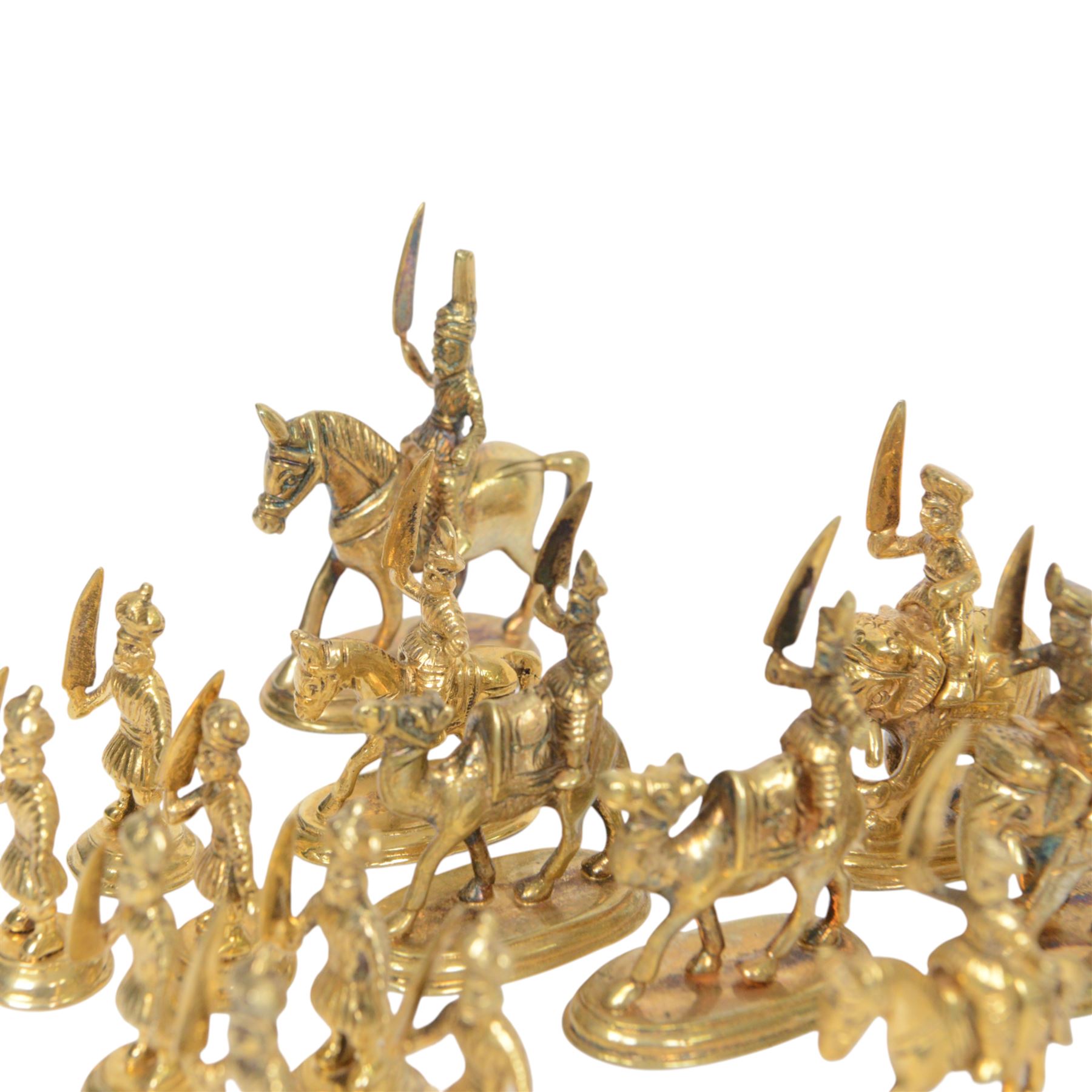 19th century Moghul Indian silver and silver gilt chess set, comprising thirty-two pieces, modelled as soldiers mounted upon elephants, camels and horses with the pawns on foot, unmarked, King H10cm