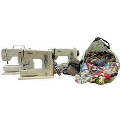 Three Bernina 801 model sewing machines, (one for parts, the other two examples untested), together with a large bag of thread. 