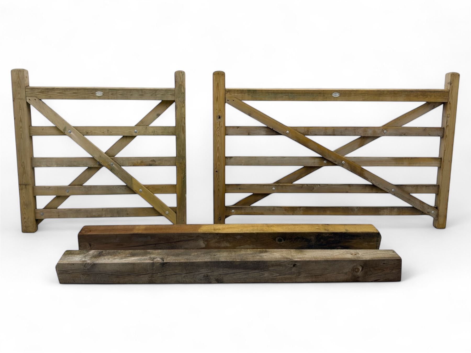 Two wooden gates with post hinges and latches