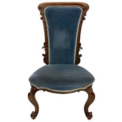 Victorian rose nursing chair, high arched back carved with scrolling foliage, serpentine seat upholstered in blue, on cabriole supports